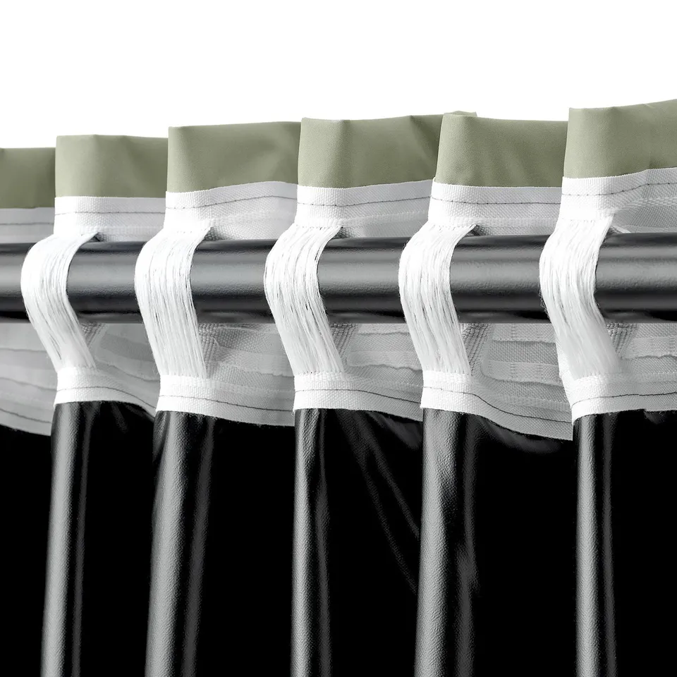 Blackout curtains hung above window, showing hanging tabs and textured back.