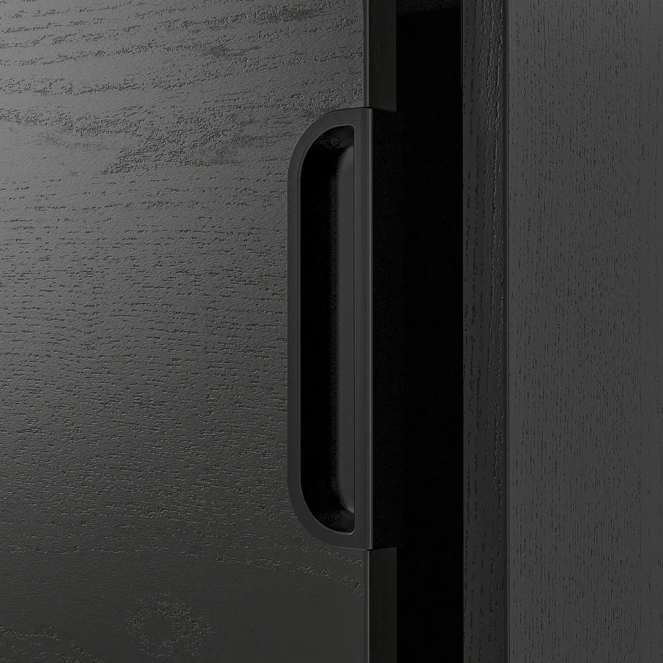 A modern, dark wood office drawer with a sleek, black handle. The handles design is clean and minimalist, offering a smooth and efficient grip.