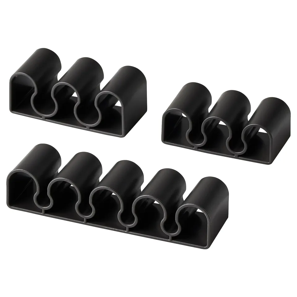 Black KALKSTUFF cable holders in various sizes, arranged in a square.