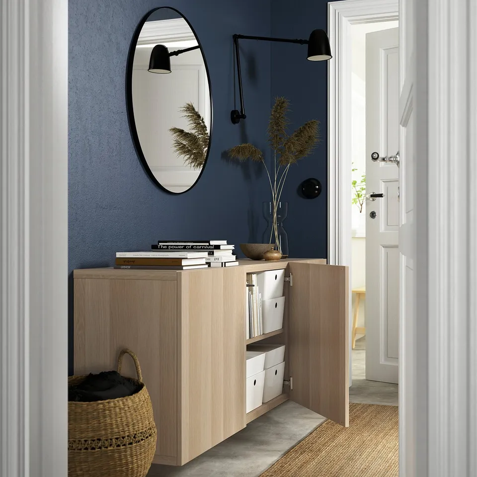 Modern entryway featuring a wall-mounted BESTÅ sideboard, with adjustable shelves and soft-closing doors, enhancing storage and organisation.