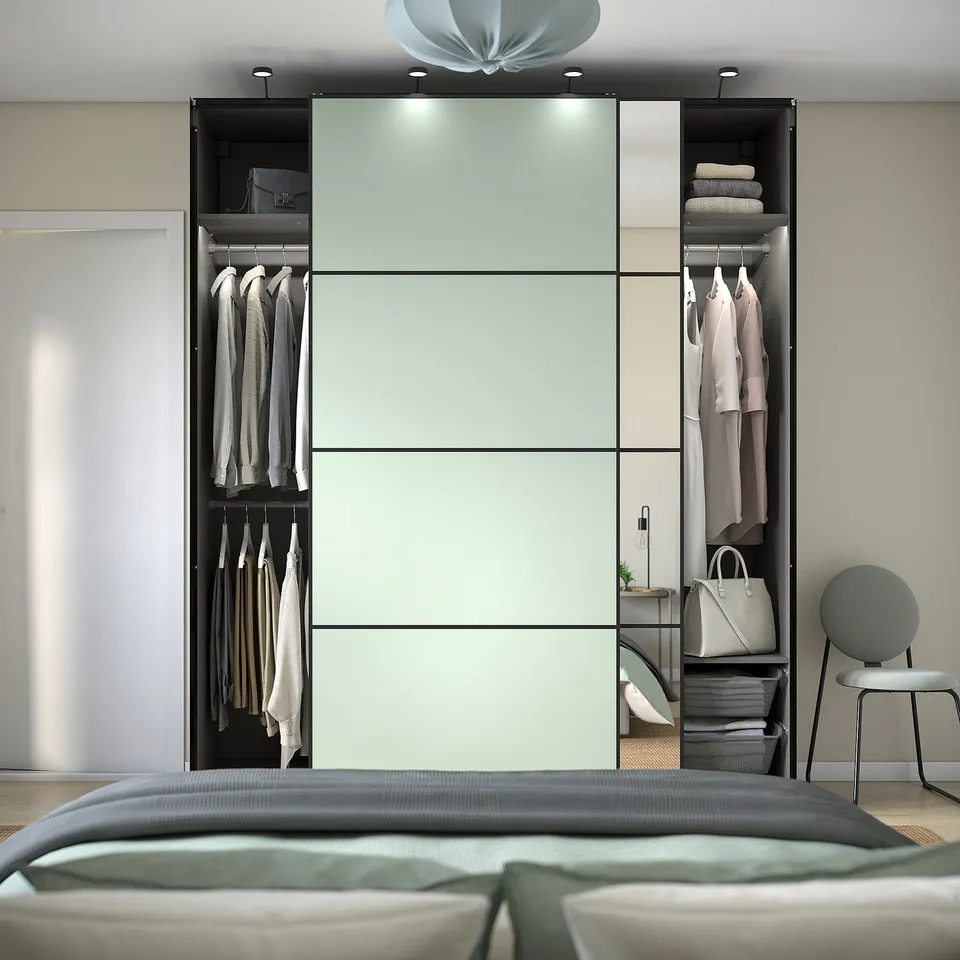 Modern bedroom with PAX wardrobe. Mirrored sliding doors, adjustable interior.