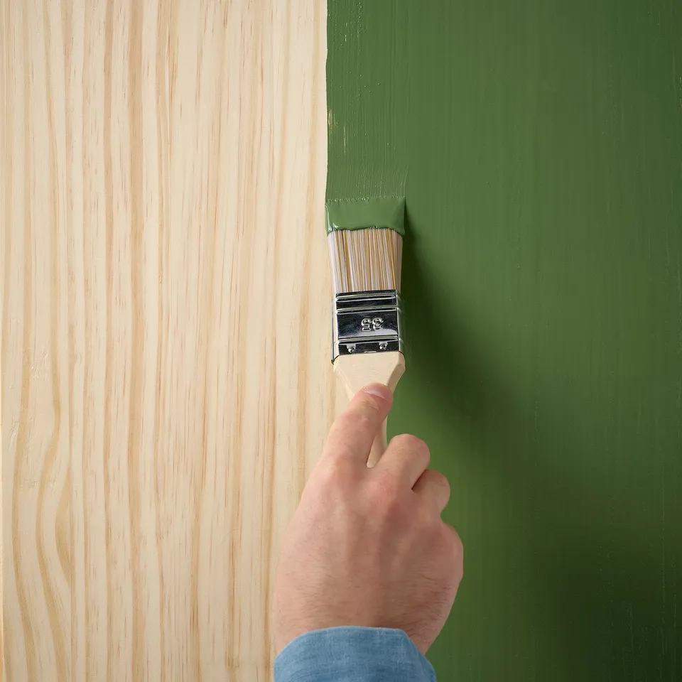 Painting wood green, highlighting grain.
