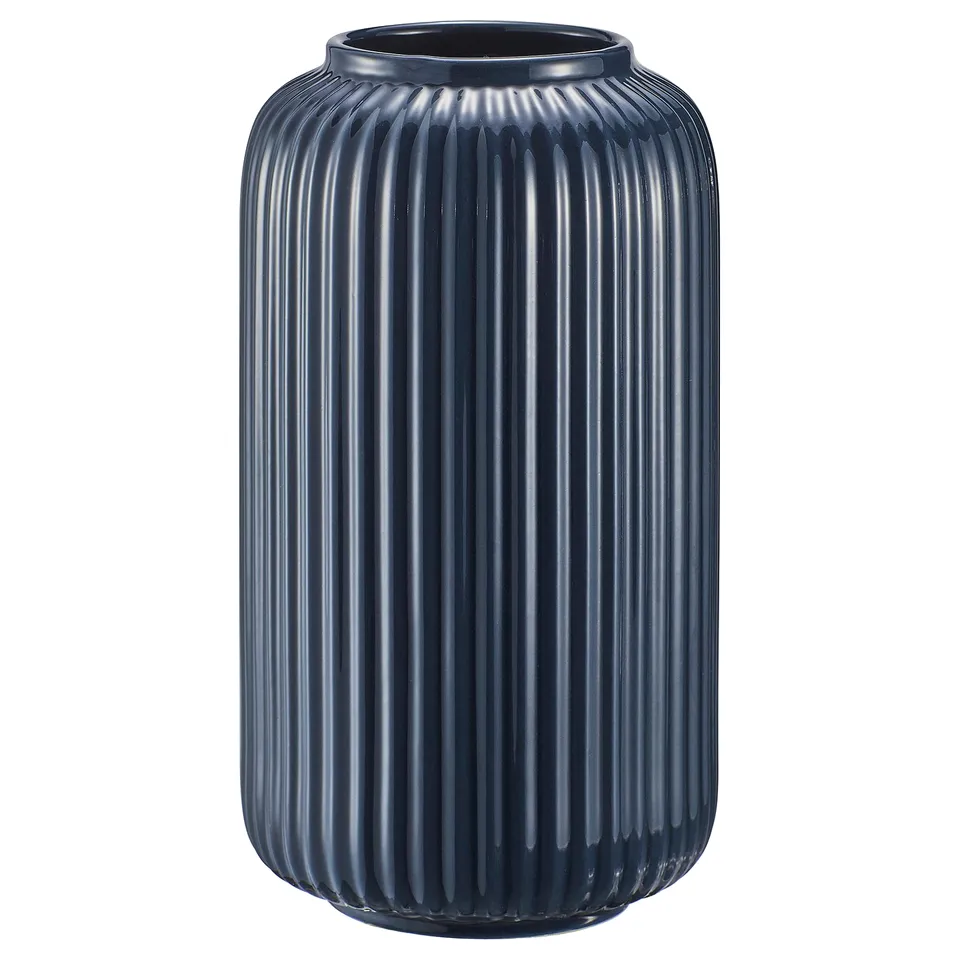 A tall, dark blue STILREN vase with a ribbed stoneware design. Its sleek, cylindrical shape makes it a stylish decor piece.