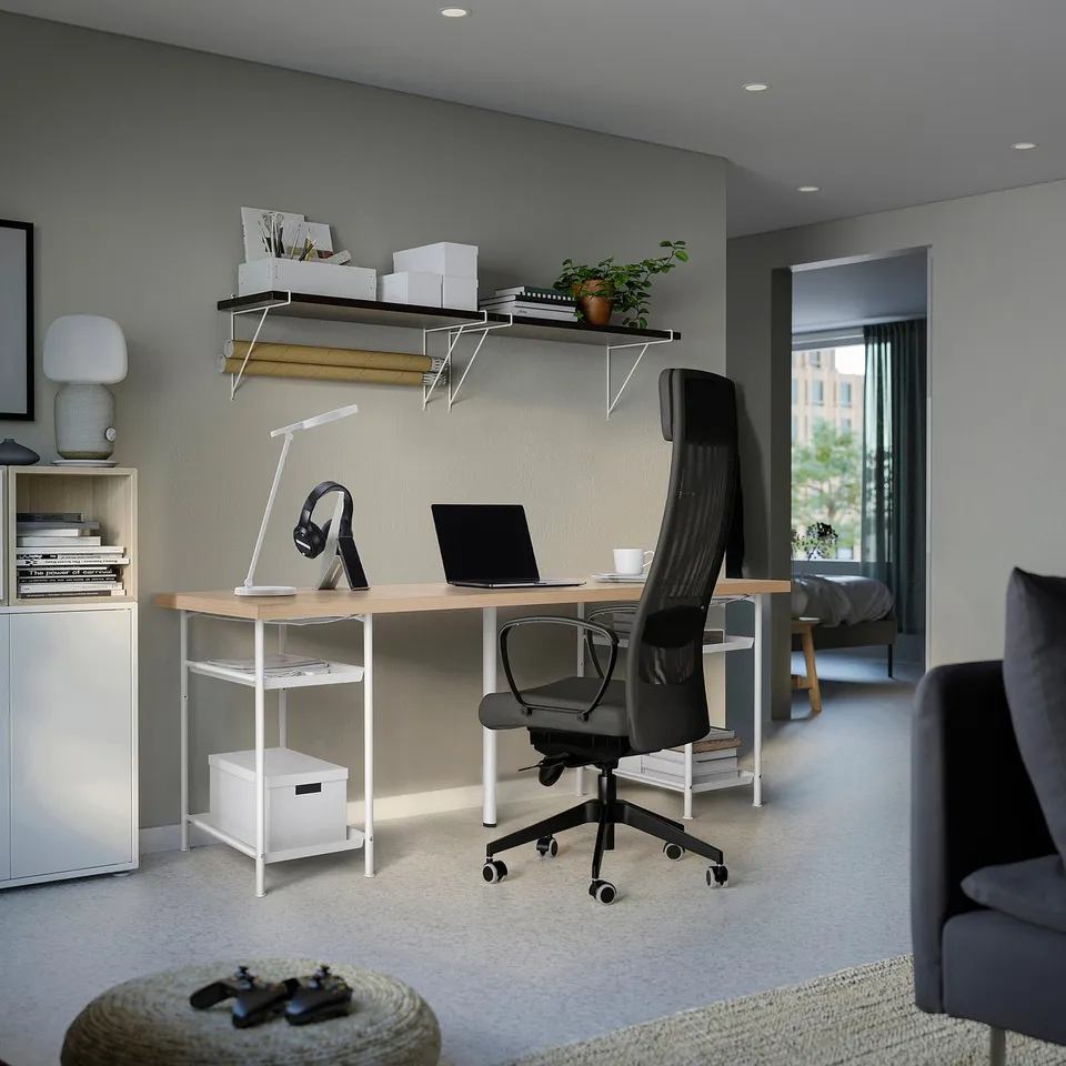 Home office with LAGKAPTEN desk, black chair, shelves, and grey walls.