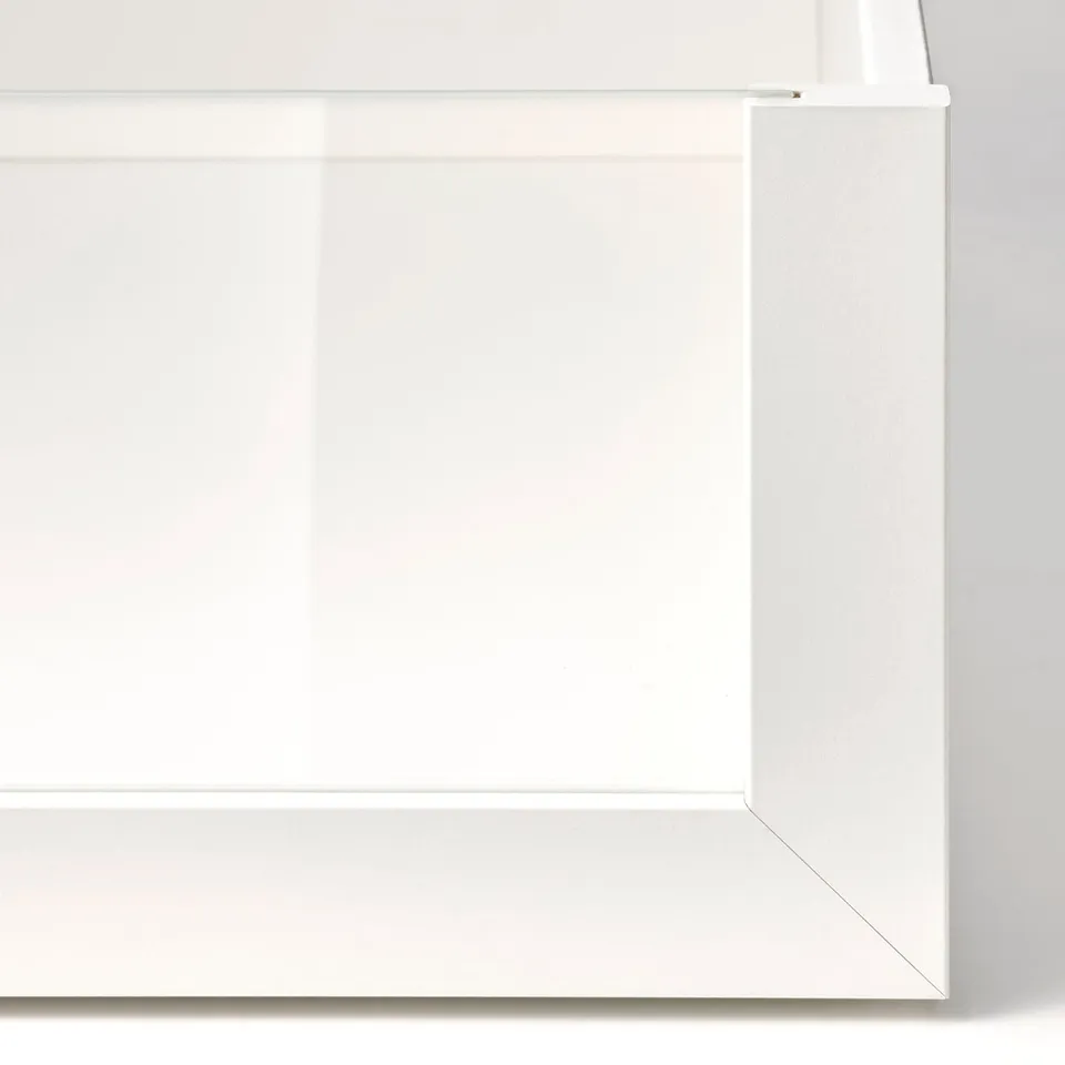 White cabinet corner with sleek, modern, closed drawer. High-quality finish with smooth edges.