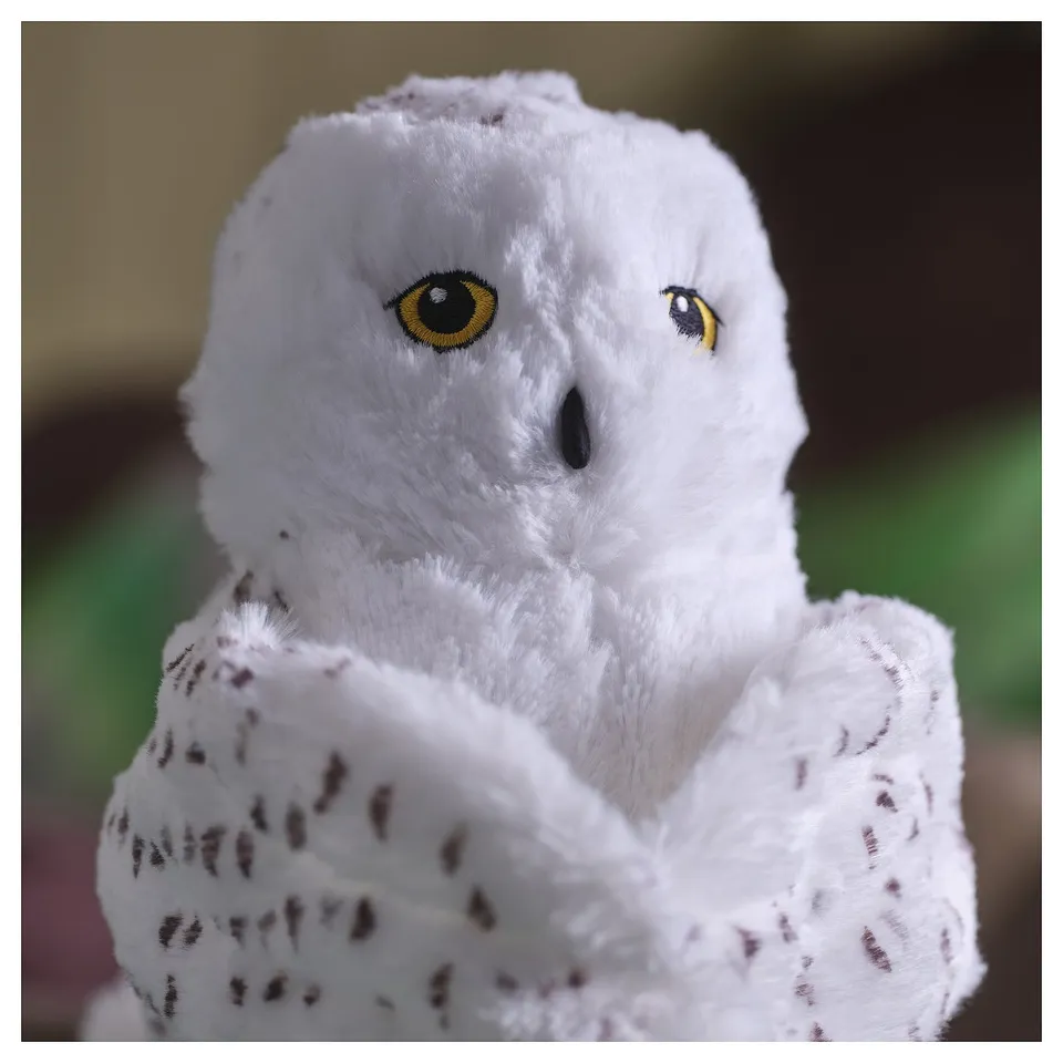 Fluffy white owl plush, detailed eyes, soft texture, huggable design.