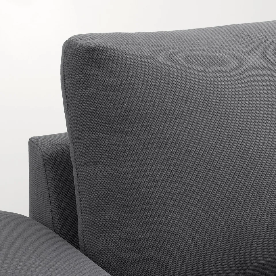 Plush, grey sofa section with ample padding, tailored stitching, and lip-style armrests, exuding comfort and quality.