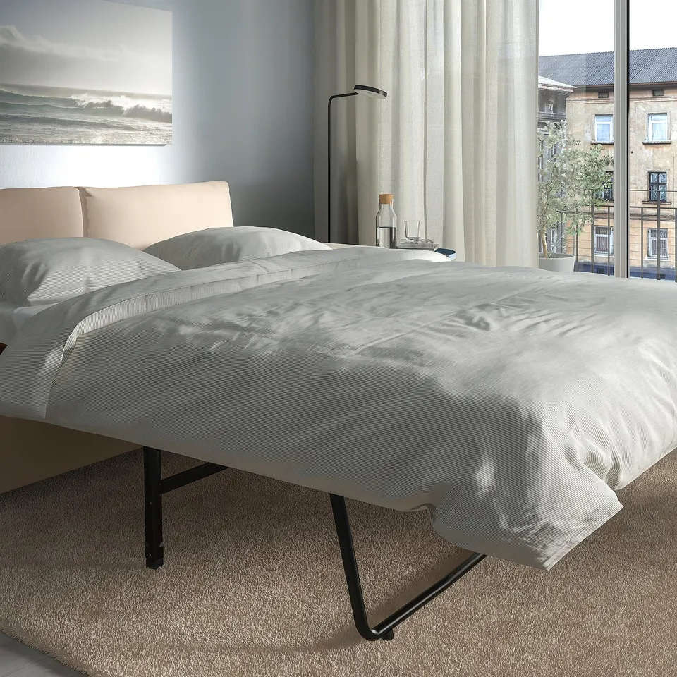 Modern grey sofa-bed with thick, comfy mattress; easily converts for sleeping.