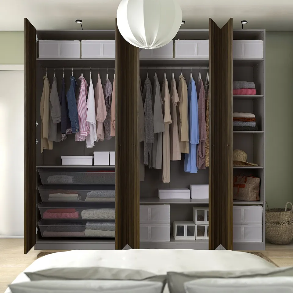 A well-organized PAX wardrobe with multiple shelves and hanging space, featuring mesh drawers and storage boxes.