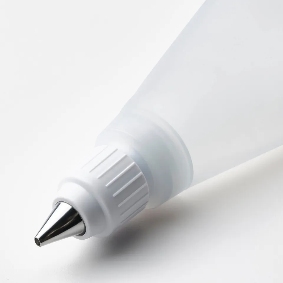 Silicone pastry bag with stainless steel tip for cake decorating.