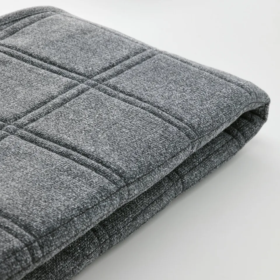 Close-up of textured, grey fabric with grid pattern, showcasing detailed stitching and high-quality material.