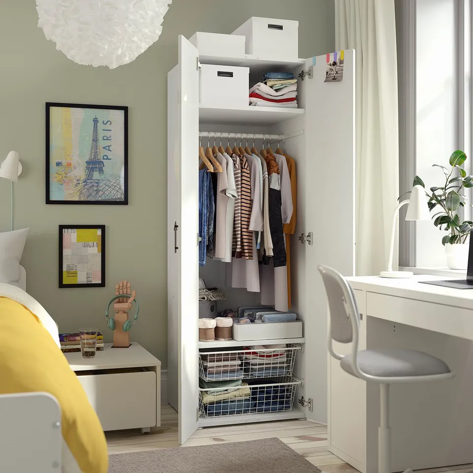 Open wardrobe displaying clothes and storage solutions, including shelves and drawers, in a neatly organised bedroom.