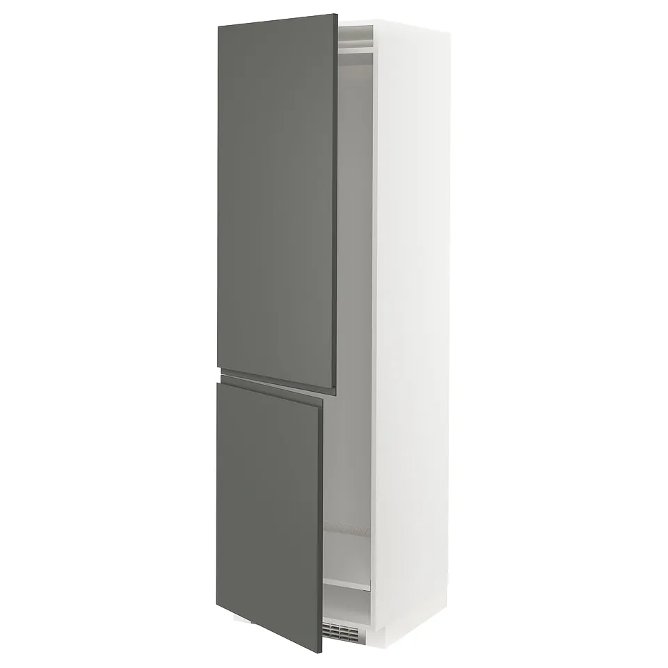 A METOD kitchen cabinet. Its tall, white with grey doors, has a modern design, and a double-door fridge setup.