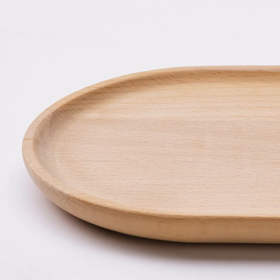 SMÖRLING: oval beechwood serving tray with smooth, rounded edges & natural wood grain texture.