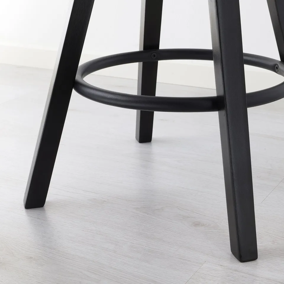 Modern black barstool base with adjustable height setting, sleek design on light wooden floor.