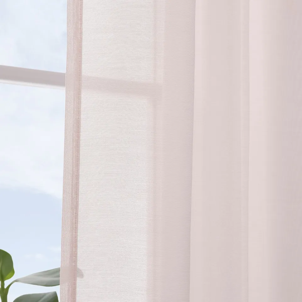 Pink sheer curtains softly diffuse sunlight. Easy instal with hooks or gliders.