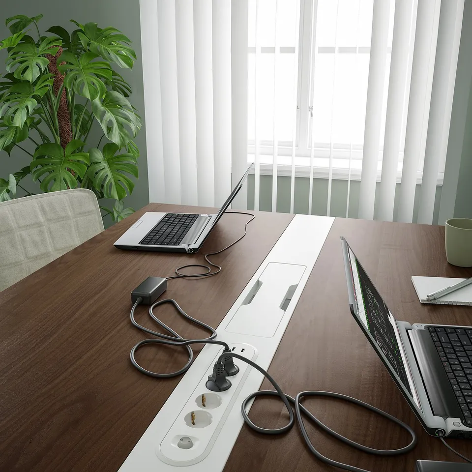 Conference table with built-in cable management and laptop spots.
