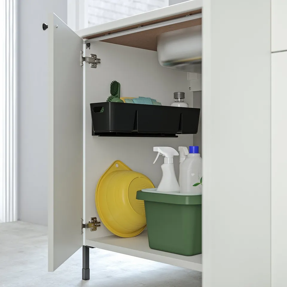 Open cabinet with slide-out tray for organised storage.