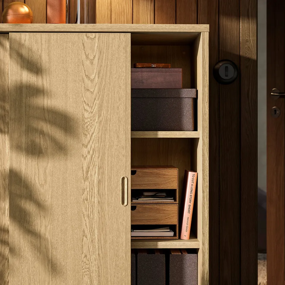 Wooden cabinet with sliding door open, revealing adjustable shelves and storage boxes.