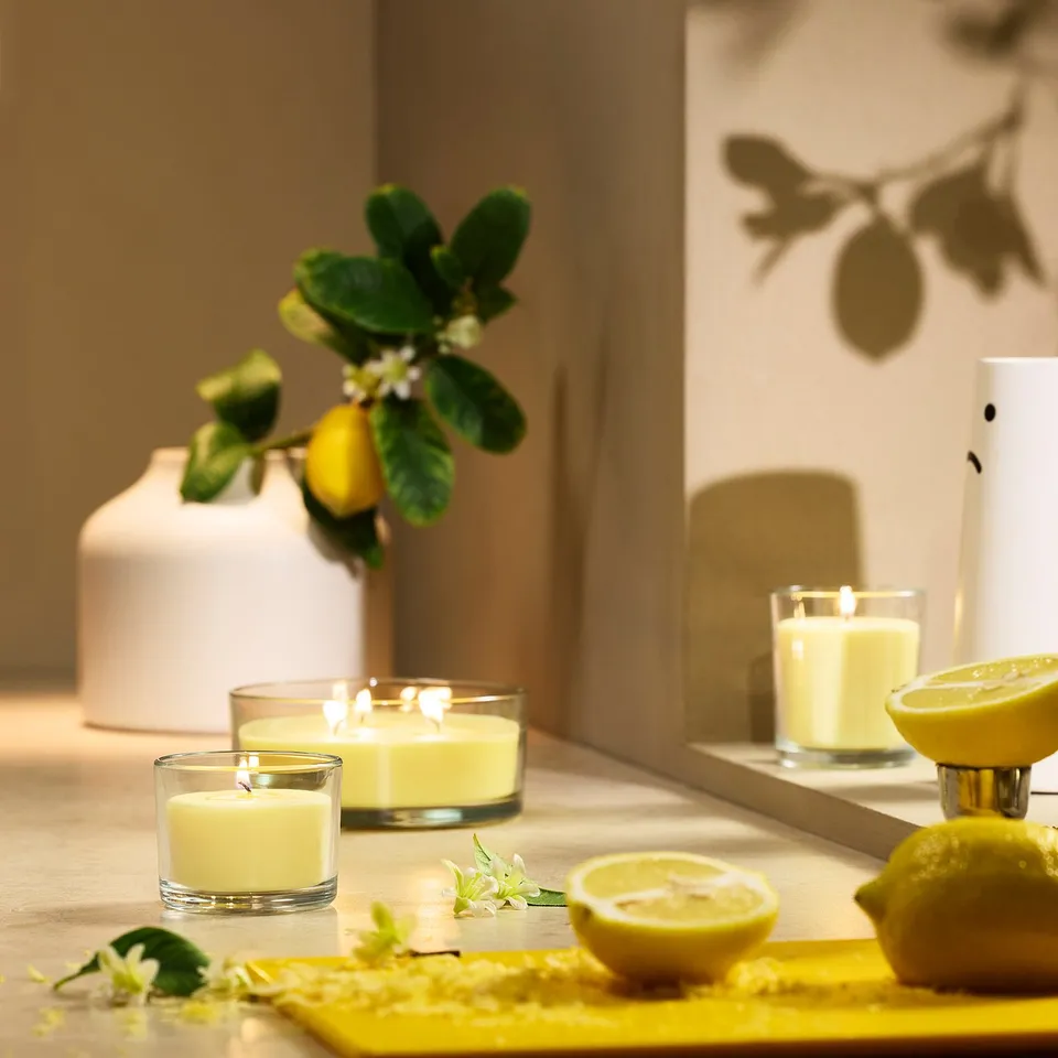 LOTSFÅGEL Scented candle in glass, 3 wicks, Citrus flower light yellow, 25 hr
