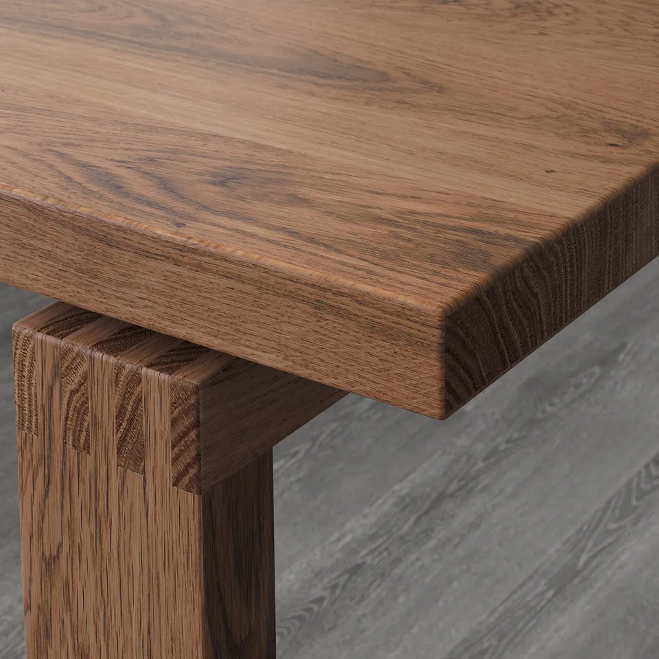 A close-up of a wooden tables corner, showcasing its sturdy construction and detailed joints.