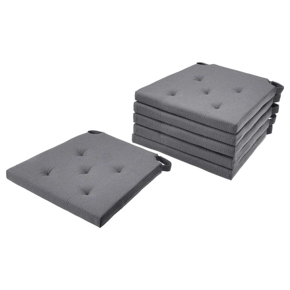 Six grey rectangular seat cushions stacked in two piles with loop fasteners visible.