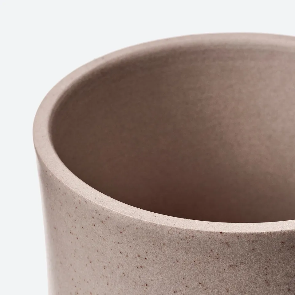 Cylindrical planter with textured, speckled surface and smooth, slightly glossy finish. Made of durable stoneware, suitable for indoor or outdoor use.