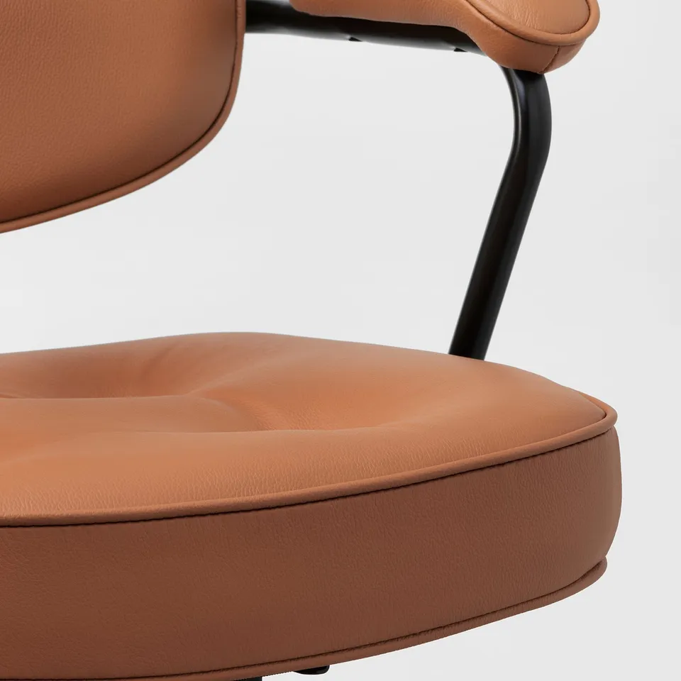 Close-up of high-quality, ergonomic chair in brown leather, showcasing soft padding, sturdy metal armrests, and sleek design.