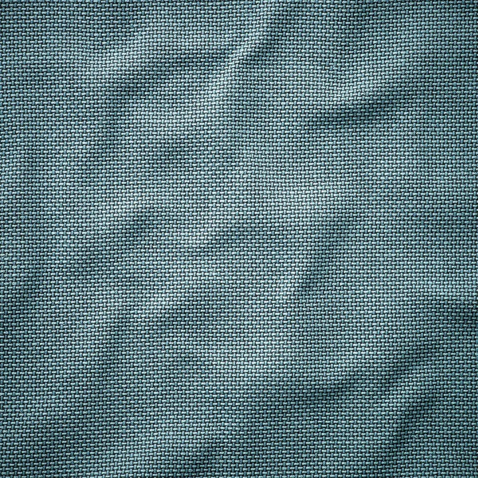Close-up of woven fabric with varying shades of grey, showcasing a textured, high-quality material.