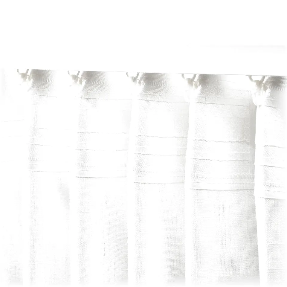 Sheer linen-like curtains with pleated tape hang, softening sunlight and ensuring privacy.