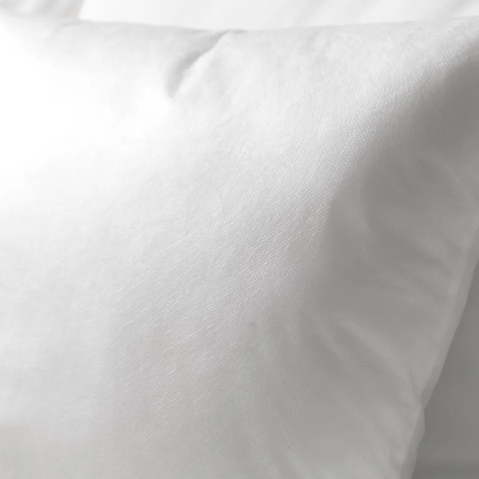 Soft, plump cushion with smooth, inviting cover, promising comfort and support.