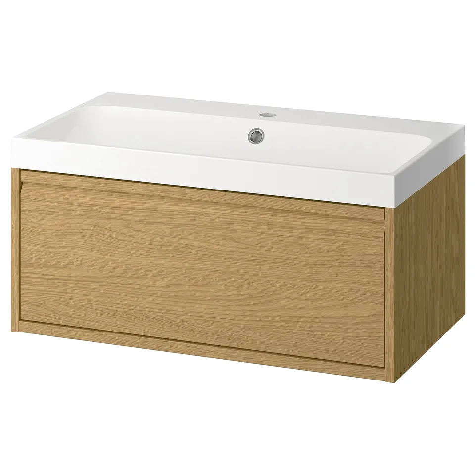 An ÄNGSJÖN bathroom vanity in oak with a white sink. It a single drawer and a clean, modern design.