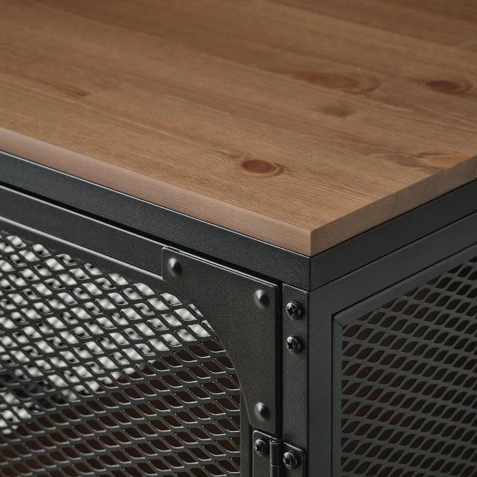 Close-up of well-crafted FJÄLLBO desk featuring sturdy wood top and perforated metal drawer, showcasing robust industrial design.