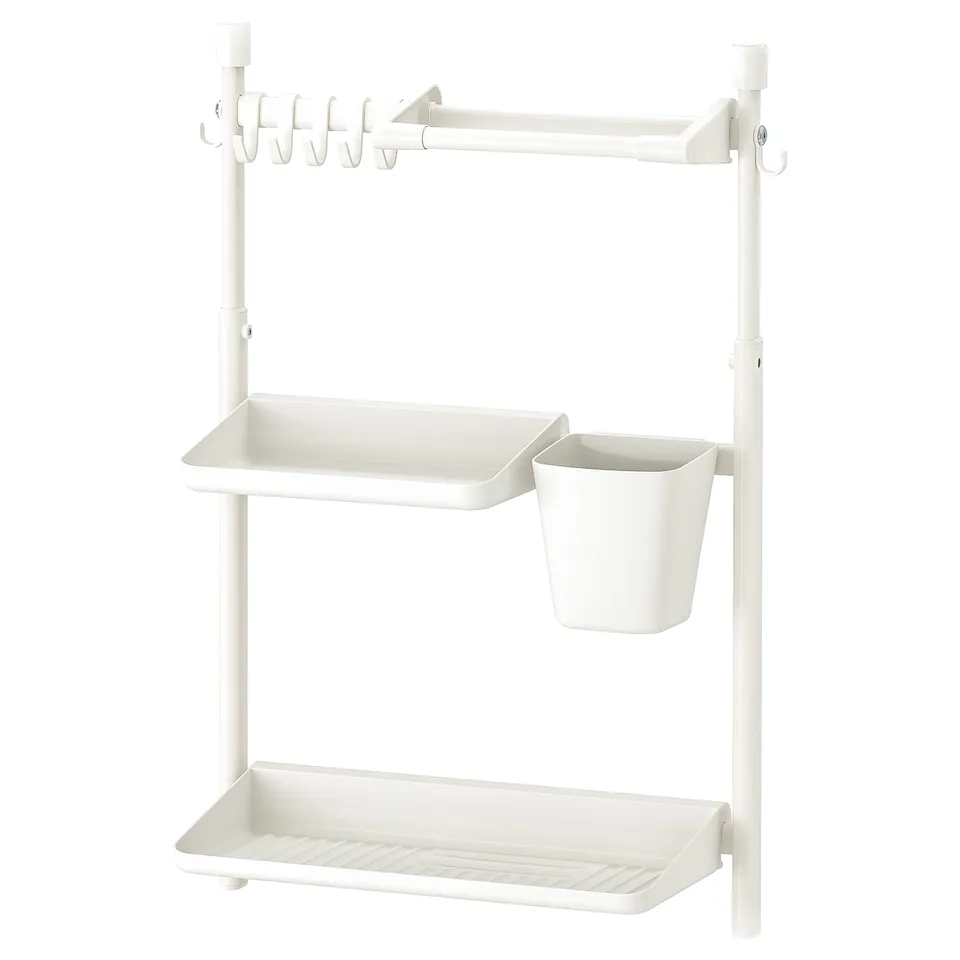 White SUNNERSTA wall shelf, metal, rectangular, three-tiered with hooks and hanging bucket.