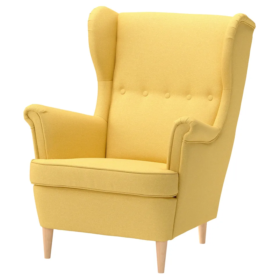 A yellow STRANDMON wingback chair with wooden legs and fabric upholstery.