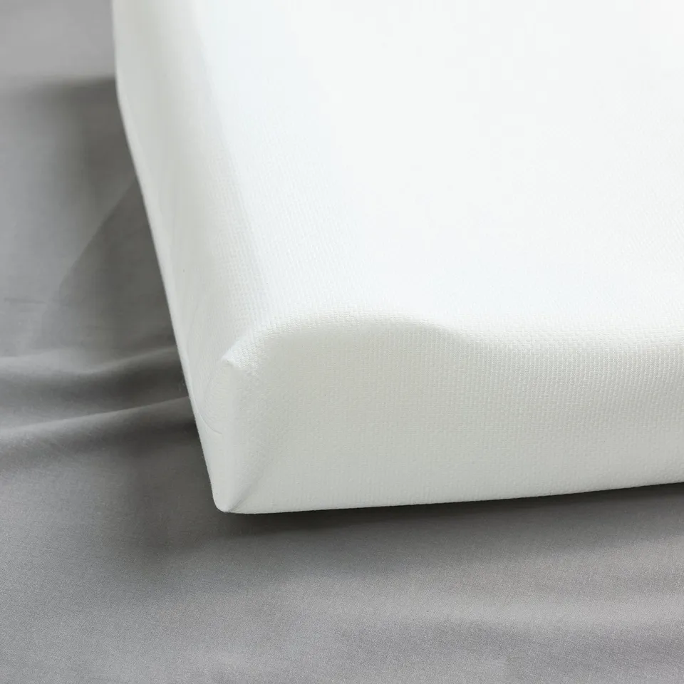 Close-up of premium white pillow showcasing high-quality fabric and firm foam filling.