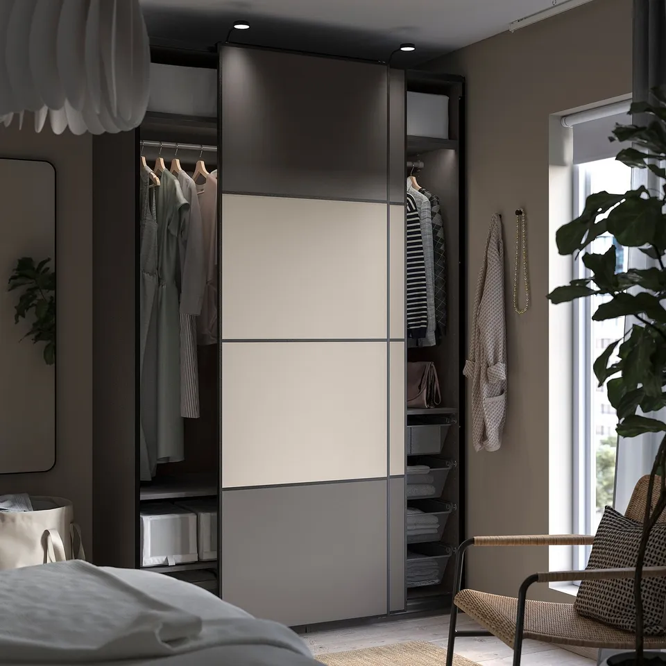 Modern bedroom with PAX wardrobe, grey and white, sliding doors, organised with shelves and hanging clothes.