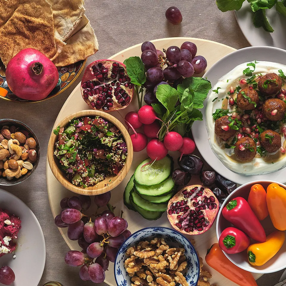 Assorted fruits, nuts, and dishes on wooden, metal, and glass blanda serving bowls, showcasing their stackability and versatile use.