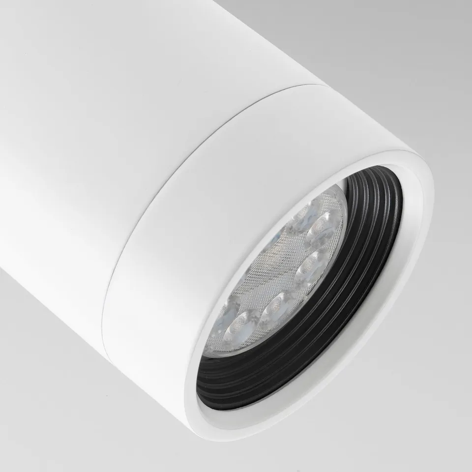 Modern ceiling light with sleek, white design and adjustable spotlights for focused illumination.