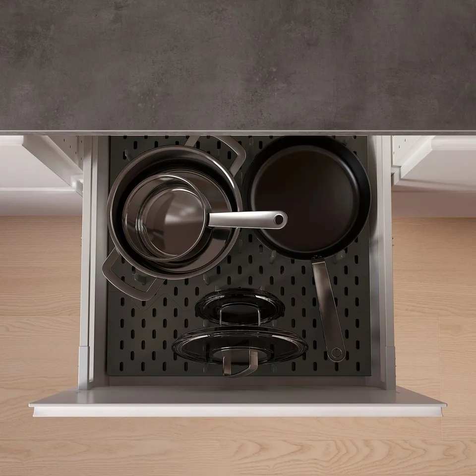 UPPDATERA drawer organisers in black, holding pots and pans.