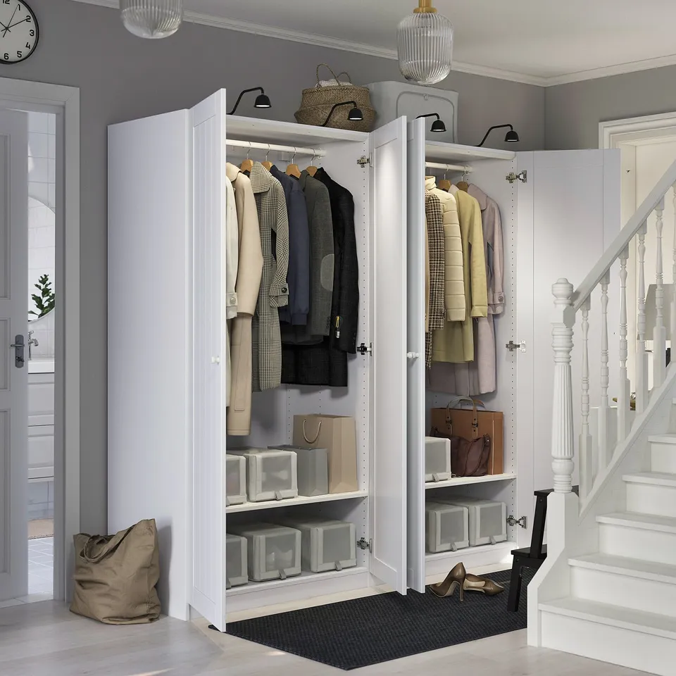 Well-organized closet with clothes, shelves, and storage boxes, featuring adjustable feet and integrated lighting.