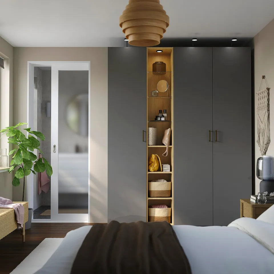 Modern bedroom with PAX wardrobe. Dark grey, glass & wood, sleek handles. Cosmetics and decor inside. Large bed, plant, bathroom view.