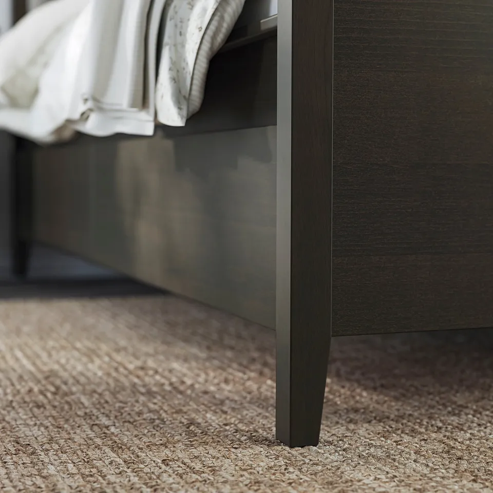 IDANÄS dark brown bed frame with white bedding, sleek design.