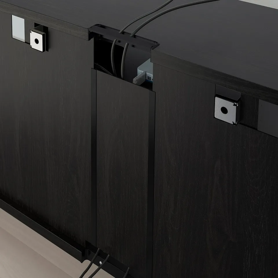 Black tv stand with adjustable shelves and cable outlets. Soft-close drawers and doors, integrated cable management.