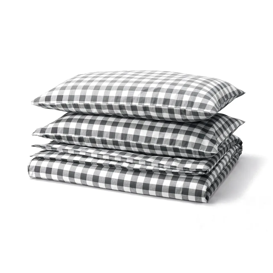 Folded black and white chequered bedding set, including duvet cover and pillows, made of soft cotton.