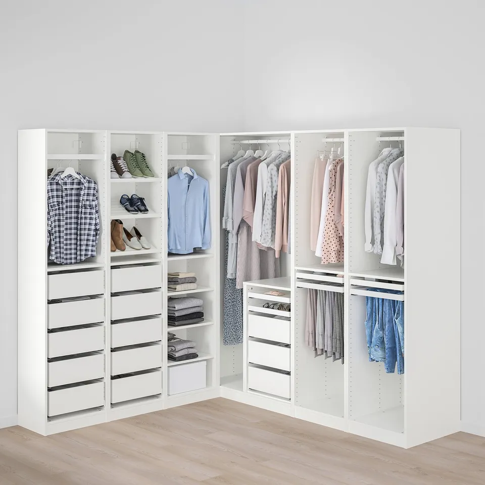 Well-organized walk-in closet with hanging rod, drawers, and shelves.