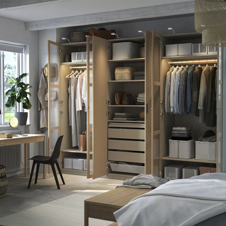 Organised wooden wardrobe with adjustable shelves, drawers, and clothes hangers. Soft-close hinges and built-in lighting.