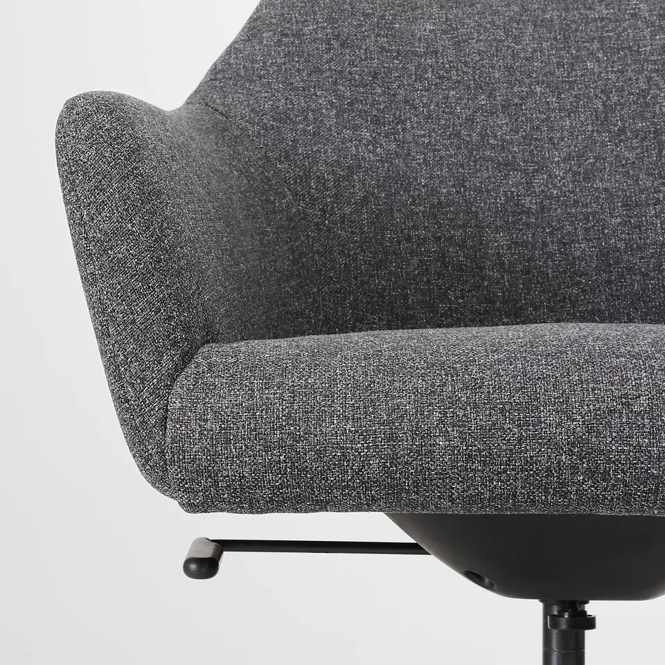 Close-up of a stylish office chair, showing grey fabric, plush padding, and sleek design.