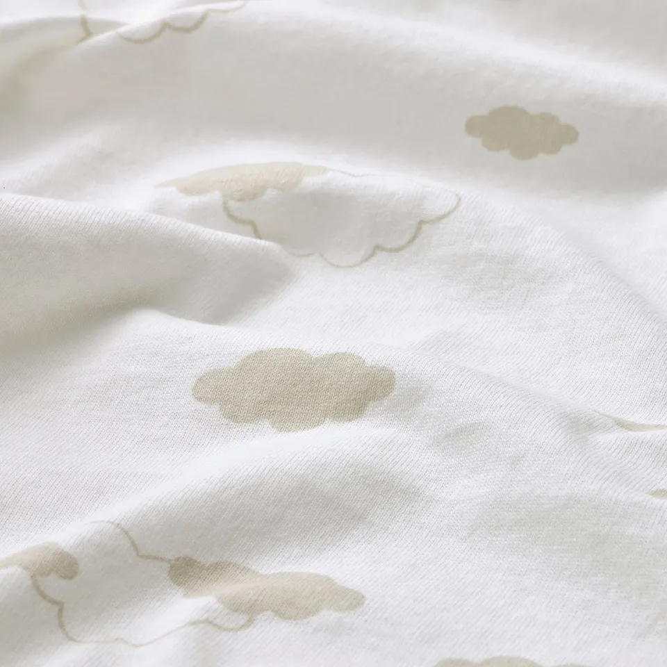 Soft, white cotton fabric with subtle, scattered cloud patterns, likely a blanket.