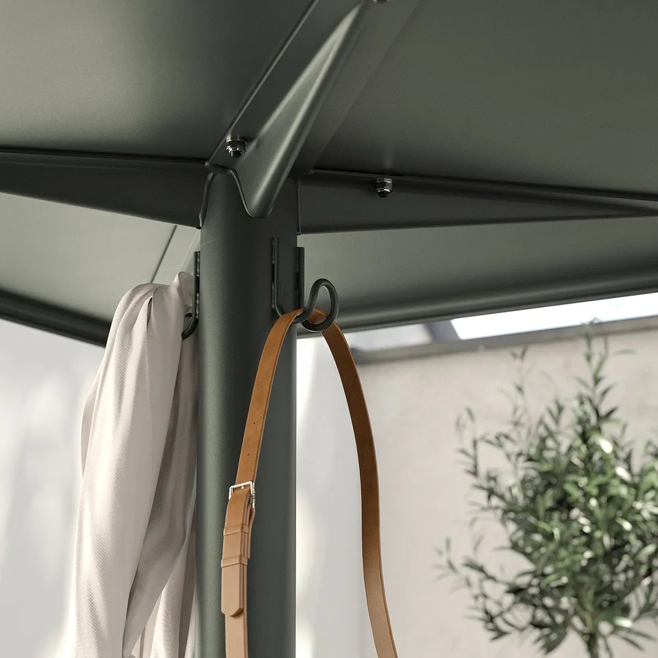 Sturdy grey outdoor table with hooks hangs items, plant nearby.